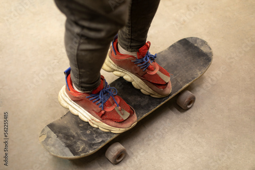 Guy on skateboard. Trick on board. Red sneakers. Extreme sports.