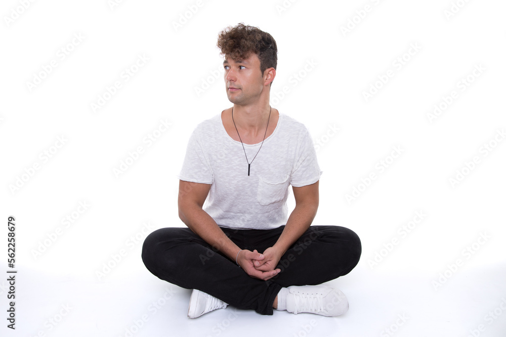 man look shocked and astonished to side while sit with crossed legs isolated on floor man look shocked and astonished to side while sit with crossed legs isolated on floor