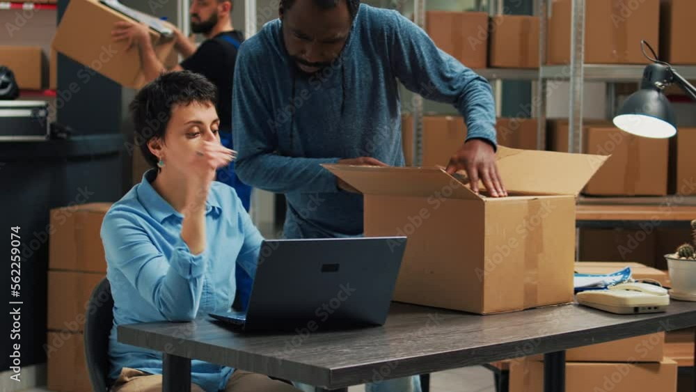 Diverse team of partners putting products in boxes and checking quality before shipping order to clients. Man and woman planning shipment with merchandise in packages, delivery logistics. Diverse team of partners putting products in boxes and checking quality before shipping order to clients. Man and woman planning shipment with merchandise in packages, delivery logistics.