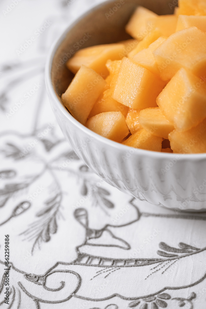 Close Up of a Bowl of Cantaloupe on Gray and White Tablecloth Close Up of a Bowl of Cantaloupe on Gray and White Tablecloth