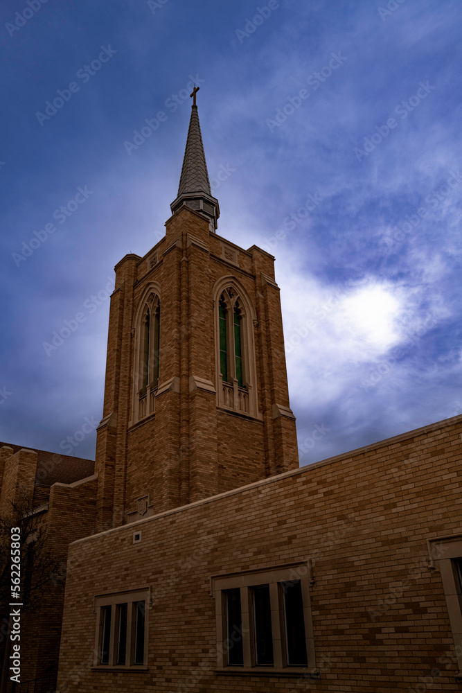 Church building on the city street and dramatic cloudscape, the First Baptist Church in Odessa, Texas, USA