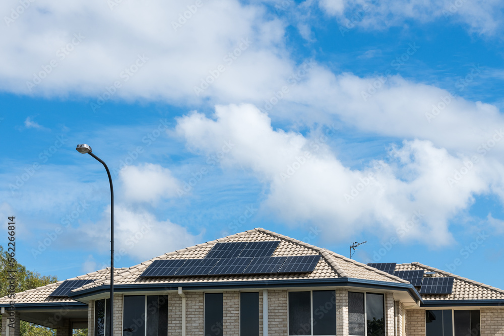 Solar panels on roof of home in Gold Coast, Australia, with copy space and blue sky