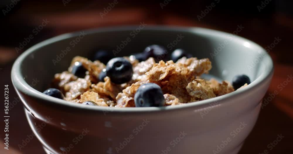 Tracking Close-up of a healthy bowl of cereal with blueberries. 4K ProRes 422 HQ DCI 4096 x 2160. Shot on the Blackmagic Cinema Camera 6K Pro on a slider, with rack focus and natural morning light. Tracking Close-up of a healthy bowl of cereal with blueberries. 4K ProRes 422 HQ DCI 4096 x 2160. Shot on the Blackmagic Cinema Camera 6K Pro on a slider, with rack focus and natural morning light.