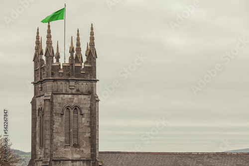 Discover Ireland concept. Top view to tower of Saint Munchin's Church in Limerick city. Clouds in the sky. Text space. Postcard style. Outdoor shot. photo