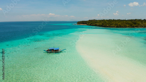 Seascape with a beautiful beach and tropical island surrounded by a coral atoll with turquoise water. Mansalangan sandbar. Summer and travel vacation concept. Balabac, Palawan, Philippines. photo