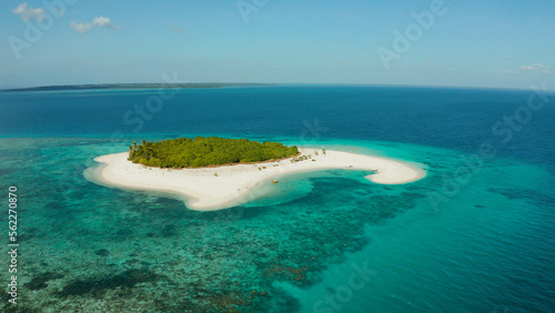 Sandy beach and tropical island by atoll with coral reef and axure water, top view. Patawan island with sandy beach. Summer and travel vacation concept.