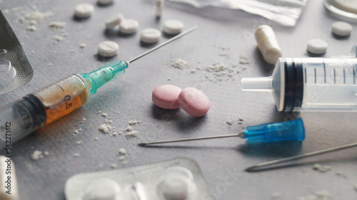 Different hard drugs on light grey table, closeup photo