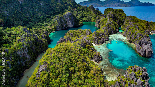 The Big Lagoon In El Nido, Palawan, Philippines. Kayaking In Shallow Crystal Clear Water, Turquoise Colored Reef, Bright Green Tree Covering Cliffs. Best vacation
