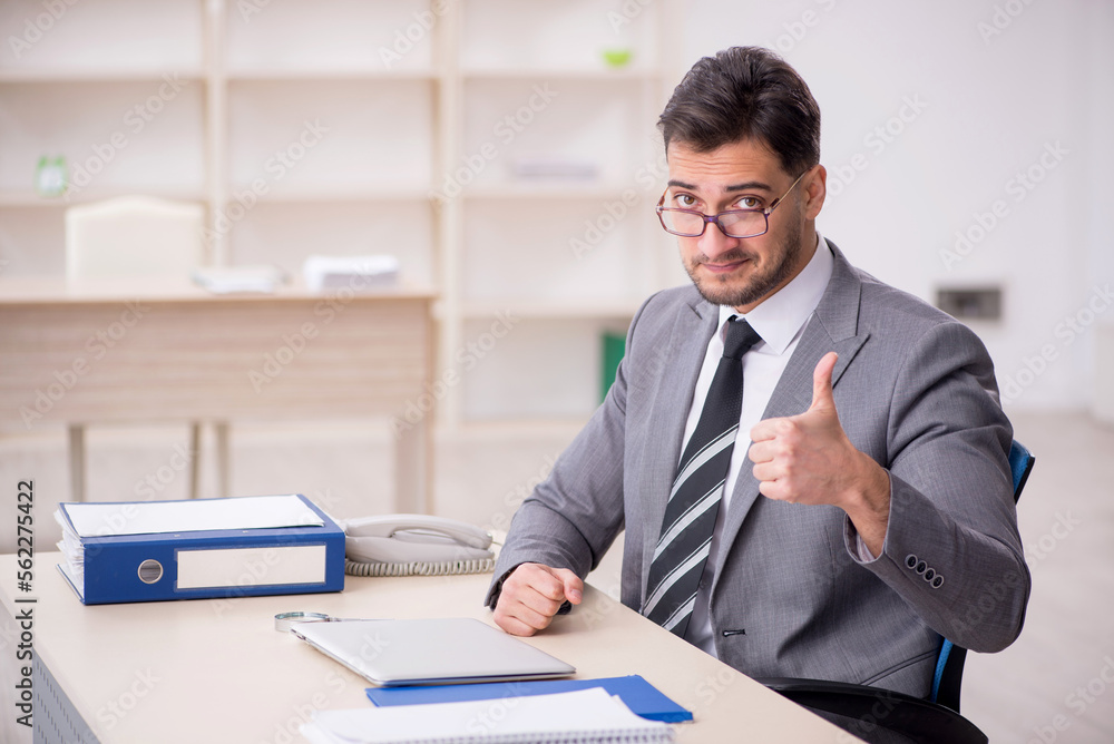 Young male employee working in the office Young male employee working in the office