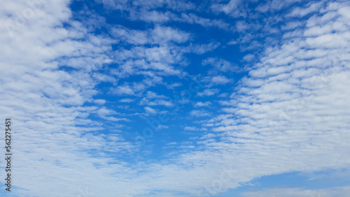 Blue sky with fluffy white clouds on a sunny day