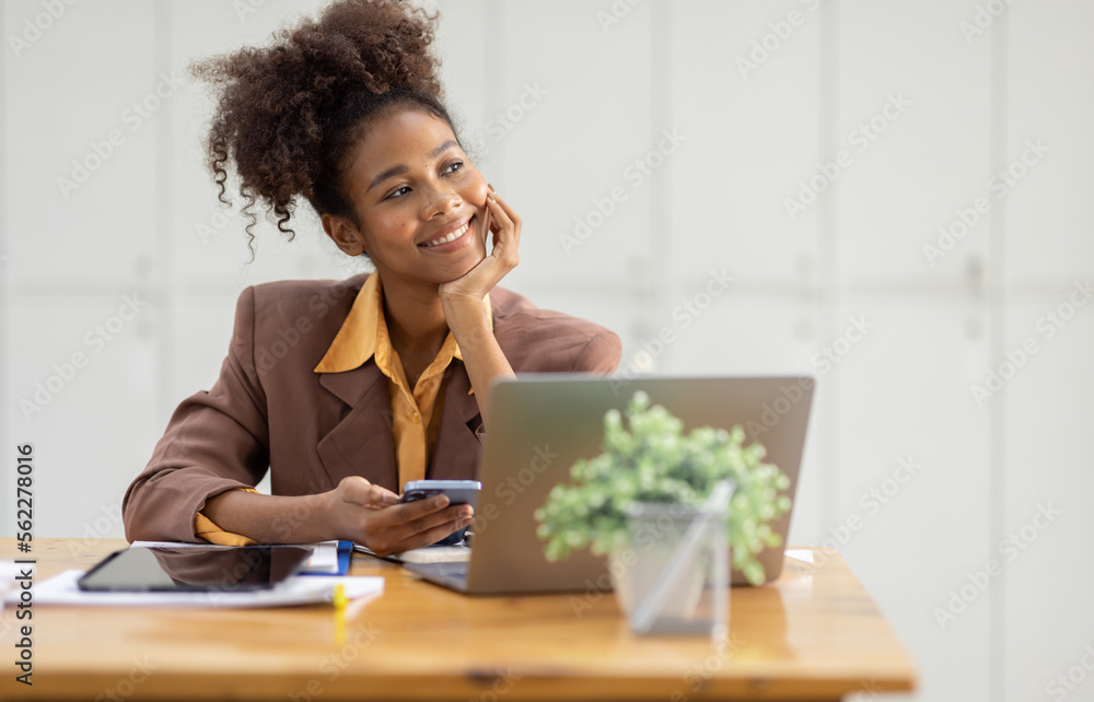 Thinking about how to take the business to technological heights. Cropped shot of an attractive young african american businesswoman working in her office, looking away. Thinking about how to take the business to technological heights. Cropped shot of an attractive young african american businesswoman working in her office, looking away.