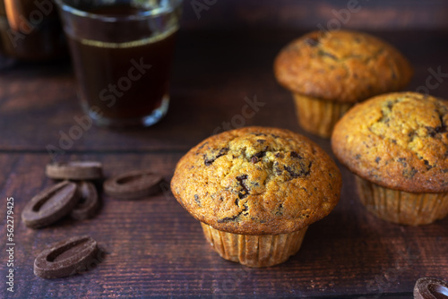 freshly baked homemade banana chocolate chip muffins on wooden table background.
