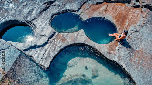 Photography Girl Sitting At Edge of Famous Figure 8 Pool In Royal National Park, Australia