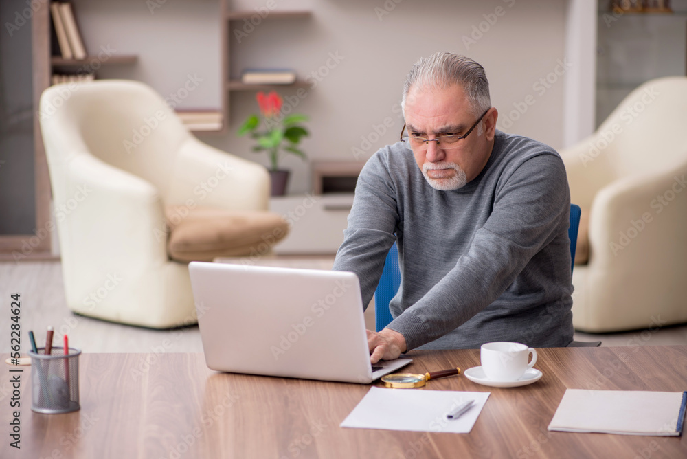 Old male employee working from home during pandemic Old male employee working from home during pandemic