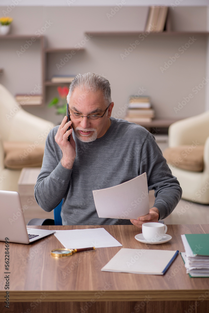 Old male employee working from home during pandemic Old male employee working from home during pandemic