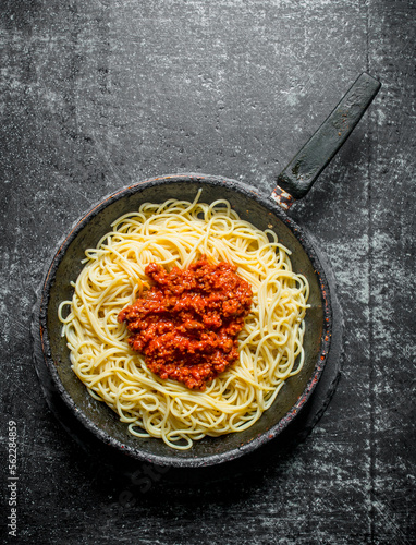 Pasta with Bolognese sauce in pan.