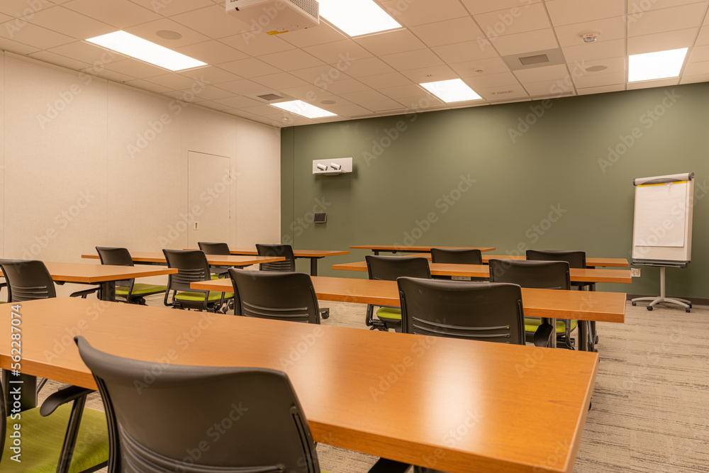 Interior of an office training, meeting, conference room with desks, chairs, and white board. Nobody included in image. Interior of an office training, meeting, conference room with desks, chairs, and white board. Nobody included in image.