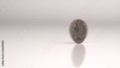 Quarter Spinning On Table In Slow Motion photo