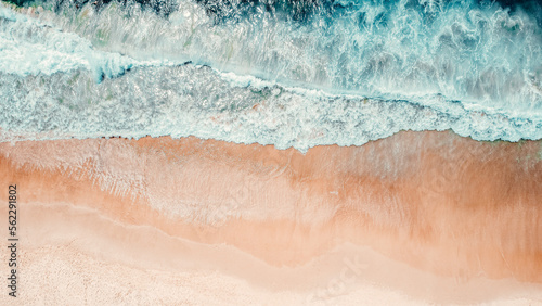 Aerial Drone Overhead Shot of Beach With No People, Blue Water, Waves Crashing Onto Beach, Blue and Teal Tones