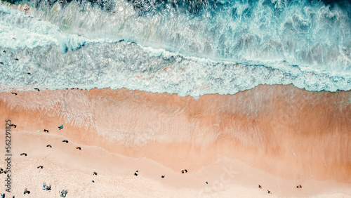 Aerial Drone Overhead Shot of Beach With People, Blue Water, Waves Crashing Onto Beach, Sunny