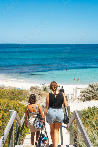 Beachgoers taking the wooden staircase to Cottesloe Beach photo