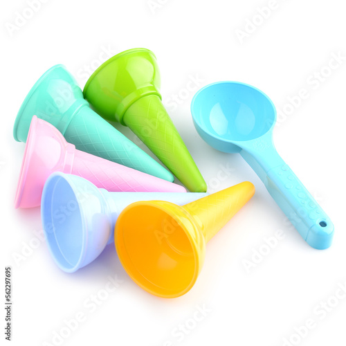Colored sand shapes in the form of ice cream on a white background, close-up. Molds for playing in the sandbox. Build sand castles. Development of motor skills in children
