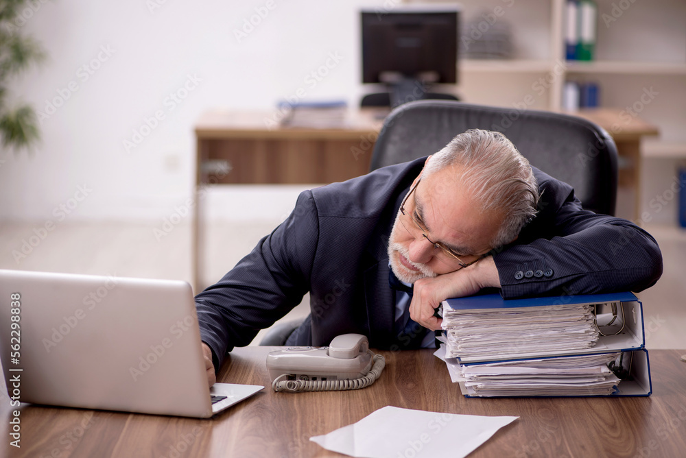 Old male employee and too much work in the office Old male employee and too much work in the office