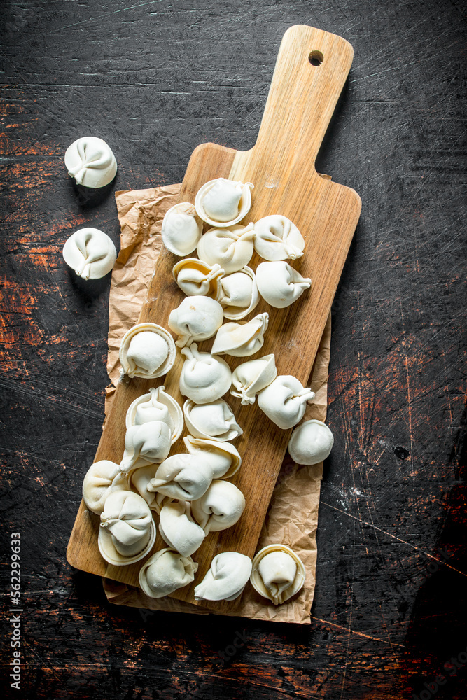 Home raw dumpling on wood cutting Board. Home raw dumpling on wood cutting Board.