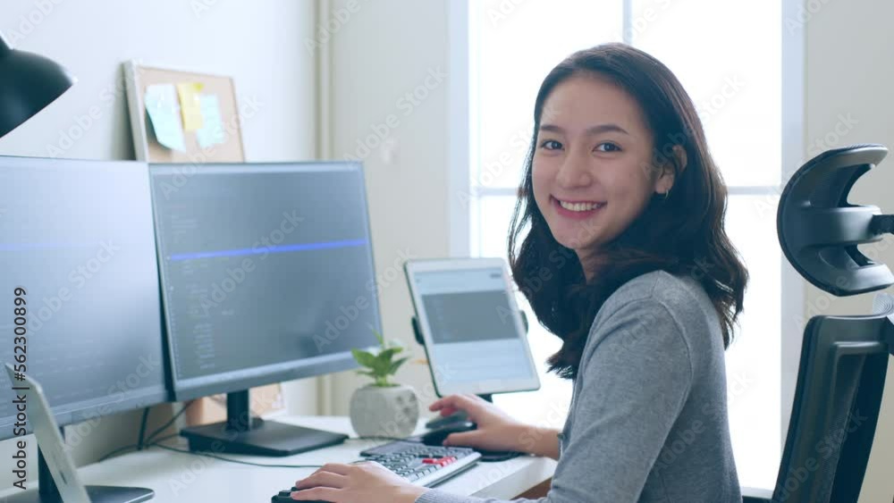 Portrait young Asian woman developer programmer, software engineer, IT support, look at camera and smile enjoy working at office. Portrait young Asian woman developer programmer, software engineer, IT support, look at camera and smile enjoy working at office.