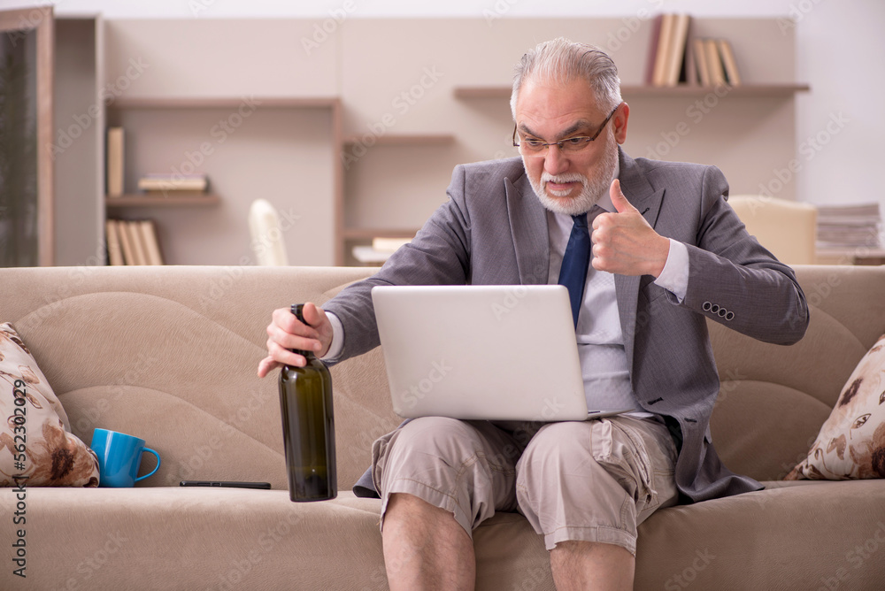 Old male employee working from home during pandemic Old male employee working from home during pandemic