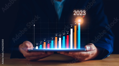 Digital marketing 2023 goals. Businessman analyzing internet marketing online, 2023 business planning, business skyrocket, online stock market analysis, stock chart next year, digital stock trading