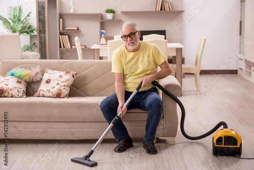 Old man doing housework at home