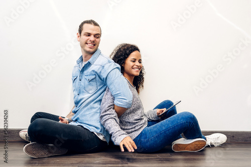 Young couple relaxing and using tablet computer.Couple checking social apps and working.Communication and technology concept