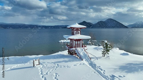 beautiful pagoda in Japan in the snow in winter, zen winter lake in Asia, tourism in Asia in winter, Japanese culture, snowy meditation landscape photo