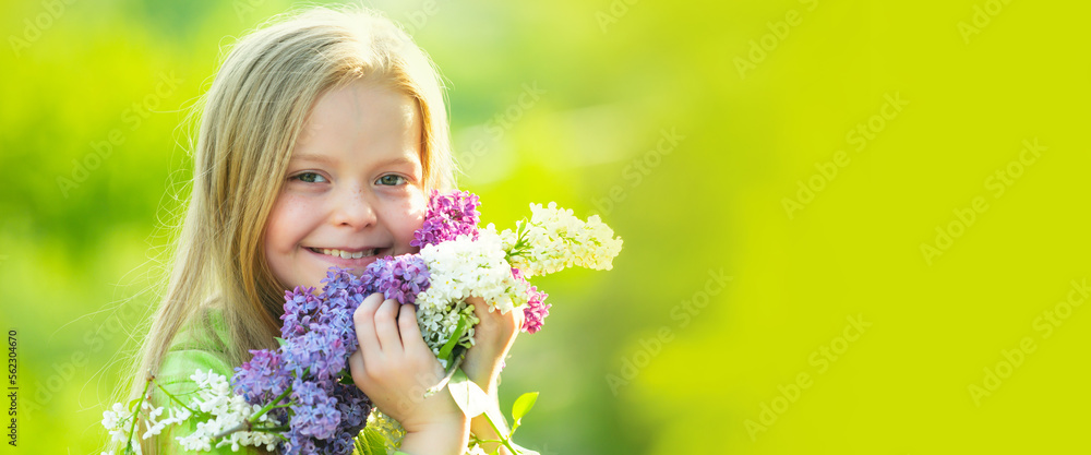 Fototapeta premium Close up face of cute child outdoors. Spring banner for website header. Beautiful teenager girl in blossom park. Funny portrait of a spring teenager girl.