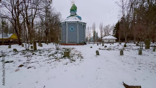 On medieval snowy cemetery in Pereiaslav Scansen, Ukraine photo