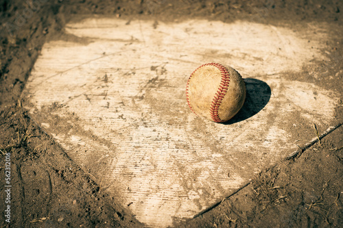 Baseball on home plate of ball field