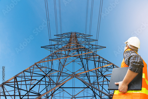 engineer checking large high voltage pylon