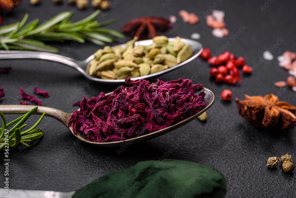 Variation of spices in metal spoons paprika, turmeric, cardamom, a mixture of allspice, thyme and rosemary Variation of spices in metal spoons paprika, turmeric, cardamom, a mixture of allspice, thyme and rosemary