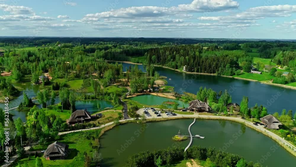 Luxury resort buildings on lake coastline surrounded by forest, aerial view Luxury resort buildings on lake coastline surrounded by forest, aerial view