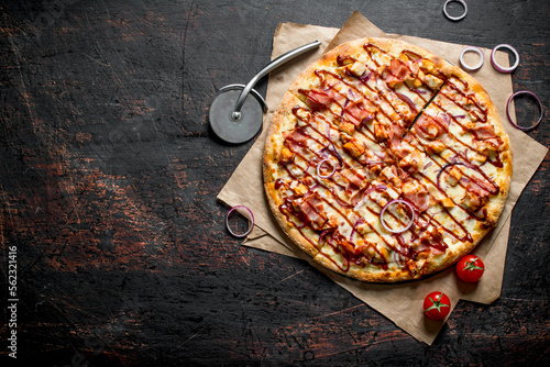 Barbecue pizza with bacon, chicken and sauce.