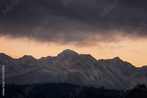 Mountain peaks covered with snow at sunset © Moose