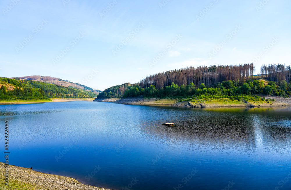 Oker reservoir near Altenau in the Harz Mountains. View from the Okertalsperre to the Oker See and the surrounding landscape. Idyllic nature by the water.
