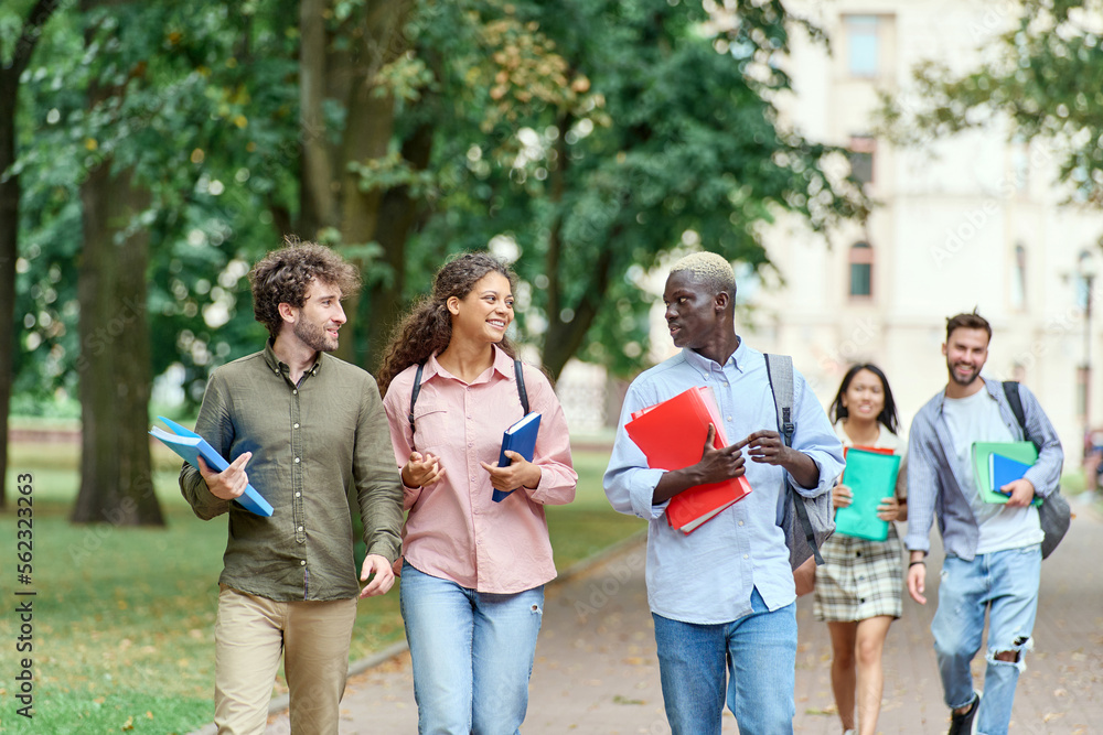 group of student friends walking through the park.