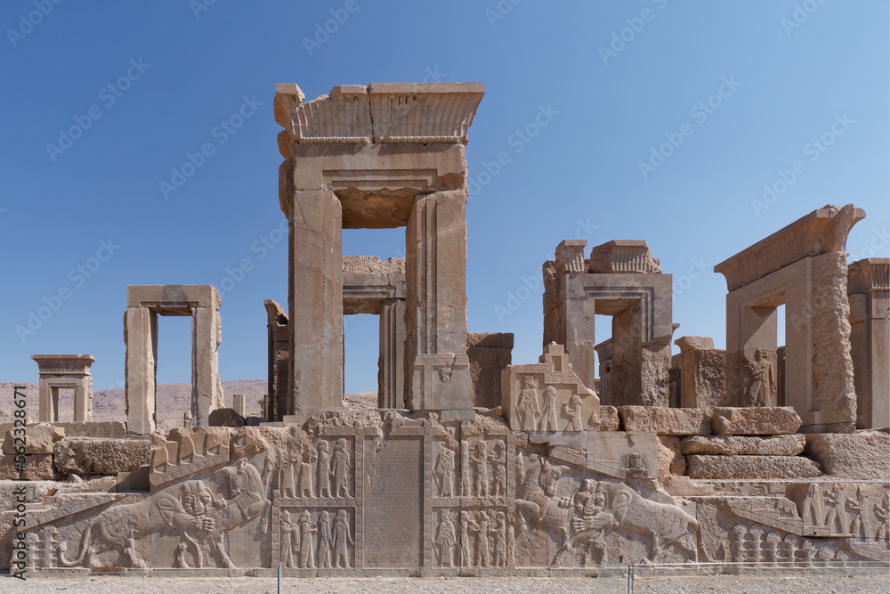 View of the ancient walls of Persepolis Palaces with a blue sky in the background, Fars province in Iran