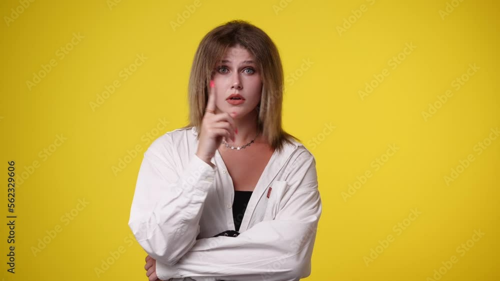 4k video of girl with cunning facial expression on yellow background. 4k video of girl with cunning facial expression on yellow background.