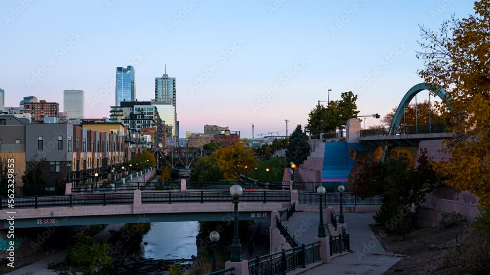 Day to night time lapse of blurred people walking along the Cherry Creek trail in Denver, Colorado. Day to night time lapse of blurred people walking along the Cherry Creek trail in Denver, Colorado.