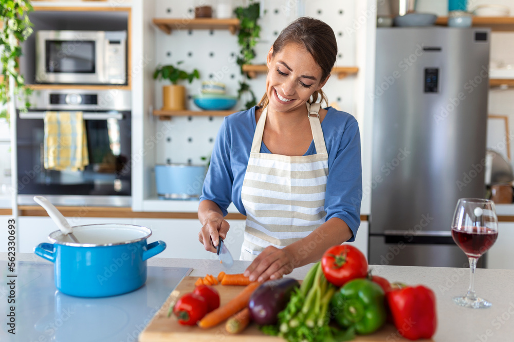 Happy Young Woman Cooking Tasting Dinner In A Pot Standing In Modern Kitchen At Home. Housewife Preparing Healthy Food Smiling . Household And Nutrition. Dieting Recipes Concept Happy Young Woman Cooking Tasting Dinner In A Pot Standing In Modern Kitchen At Home. Housewife Preparing Healthy Food Smiling . Household And Nutrition. Dieting Recipes Concept