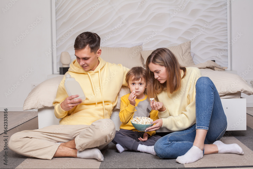 Cute adorable family sitting by the bed Cute adorable family sitting by the bed