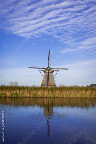 iconic windmills in Kinderdijk Netherlands. Landmark buildings originally made to pump water out of low land polder to preserve land reclaimed from the sea © drew